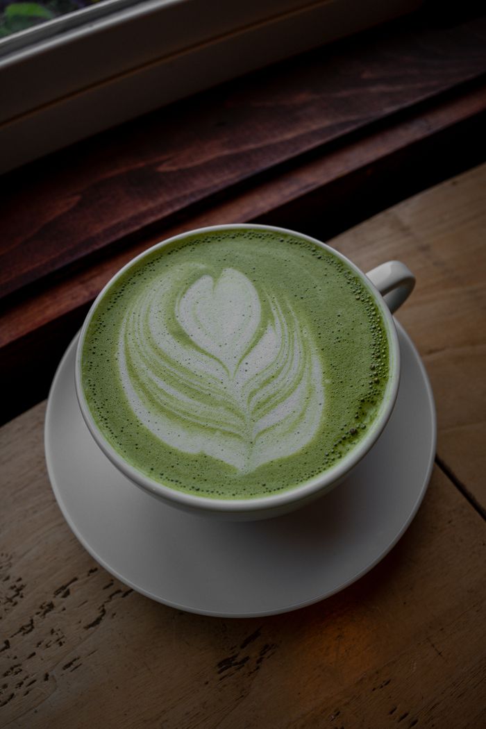 Artistic matcha latte with latte art in a cozy indoor setting. Perfect for cafes.