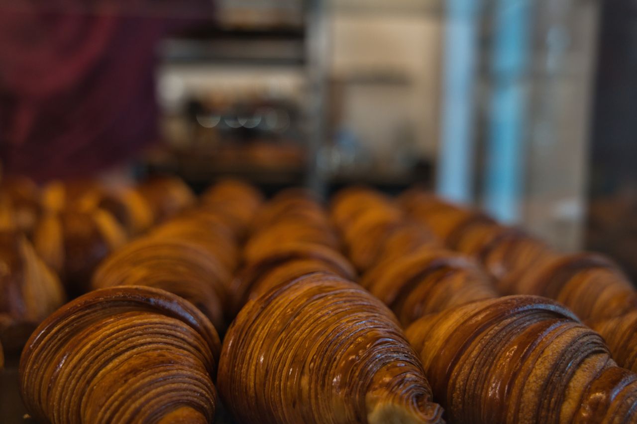 Close-up of artisanal croissants freshly baked, displayed in a Berlin bakery.